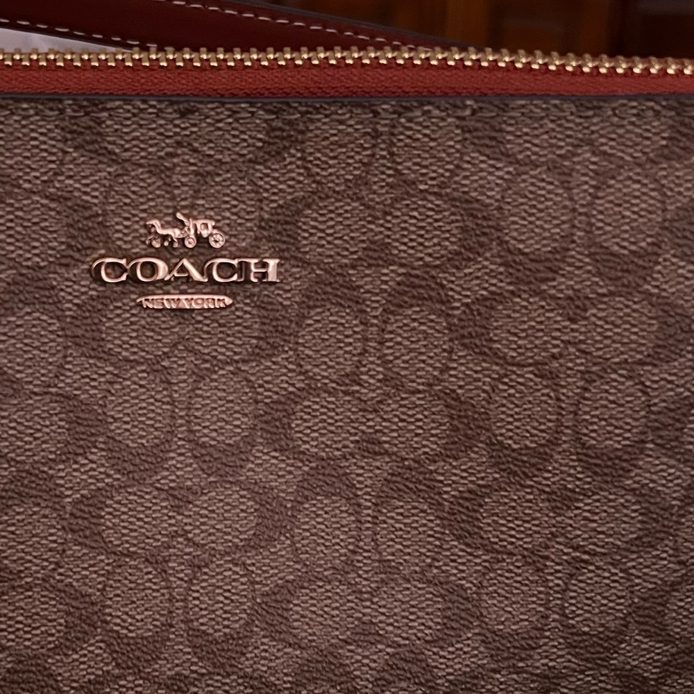 Coach signature pattern clutch